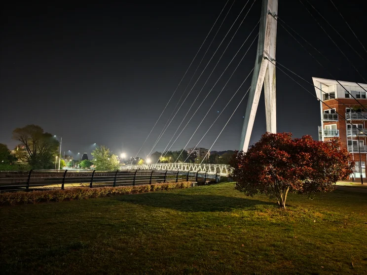 A bridge crossing a river at night