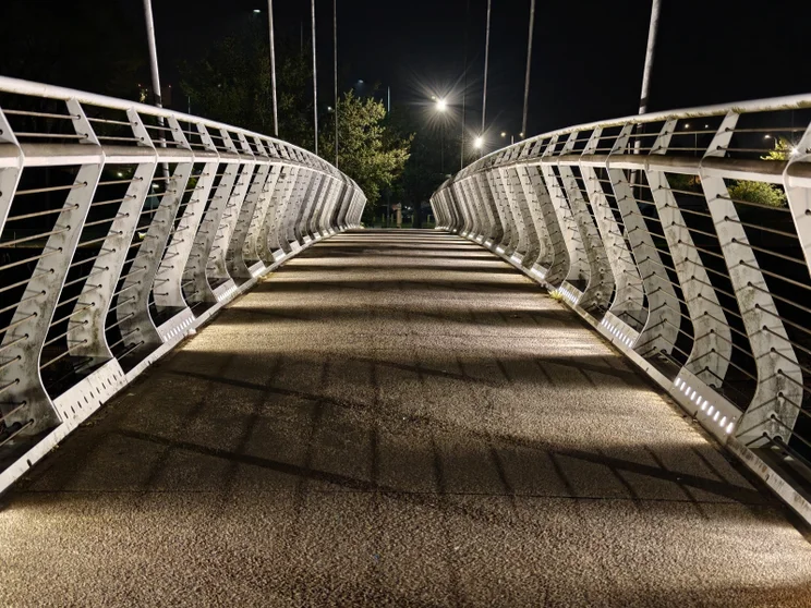 3x zoom of a bridge, white railings on both sides
