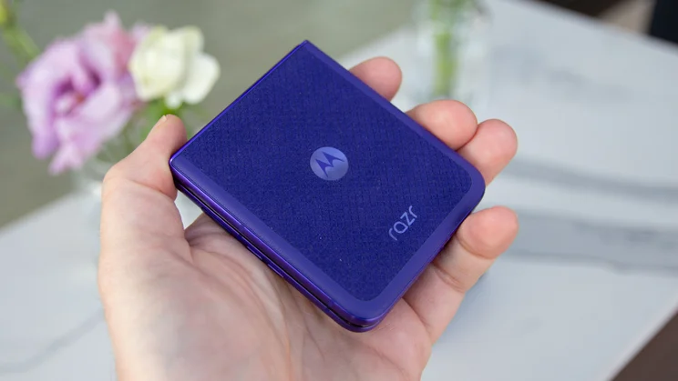 Razr 70 Ultra folded in hand, rear view in purple colourway