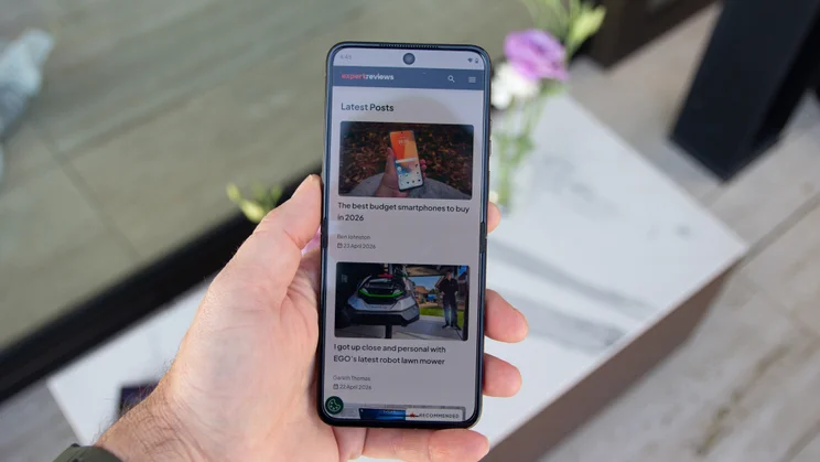 Razr 70 Ultra open in hand, displaying Expert Reviews homepage