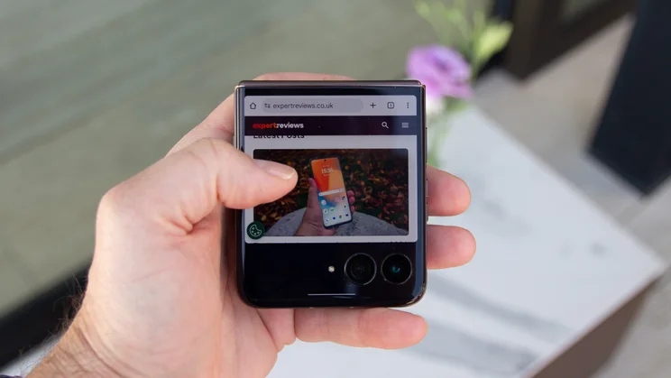 Razr 70 Ultra folded in hand, displaying Expert Reviews homepage