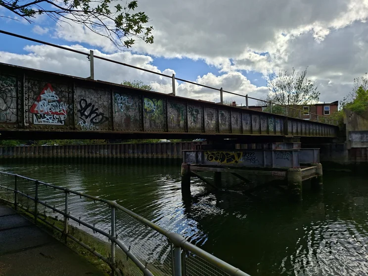 A metal bridge crossing a river