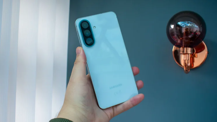 Samsung Galaxy A57 in hand, rear view