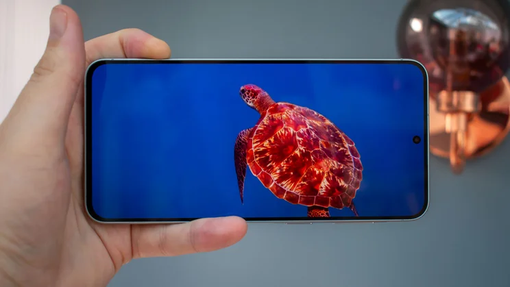 Samsung Galaxy A57 in hand, displaying a nature video