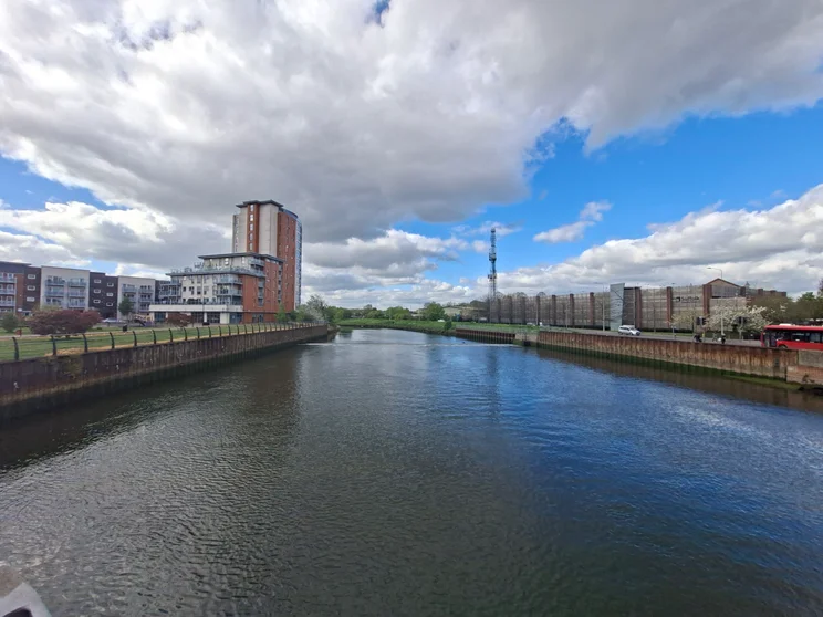 Wide-angle shot of a river with buildings on both sides