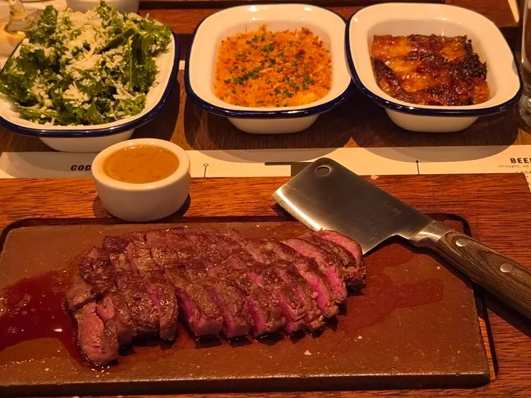 A steak dinner with vegetable sides