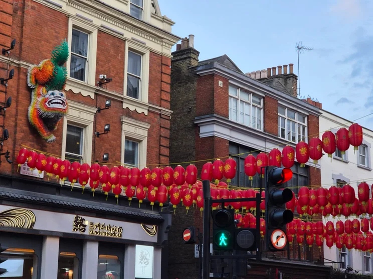 Red lanterns strung across a street in Chinatown