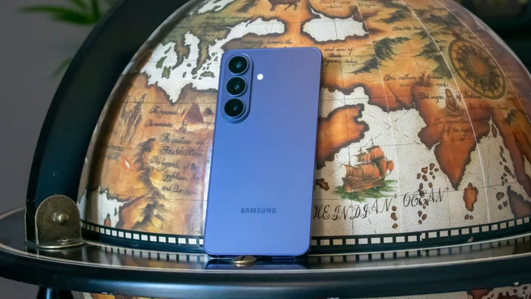 Samsung Galaxy S26 leaning on a globe, rear view