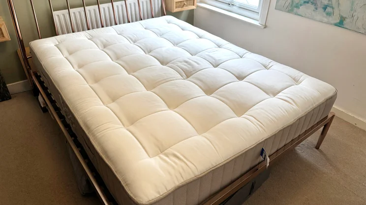 The Simba Natural Hybrid Escape mattress on a bed frame in a bedroom