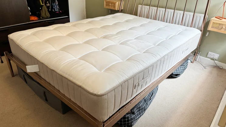 The Simba Natural Hybrid Escape mattress on a bed frame in a bedroom