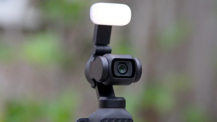 The DJI OSMO Pocket 4 with optional fill light attached to the rear of the lens housing