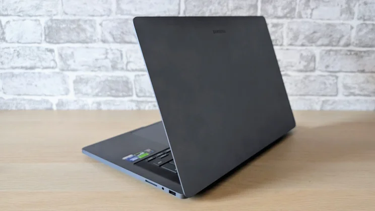 The Samsung Galaxy Book6 Ultra, half open, pictured from the rear right quarter