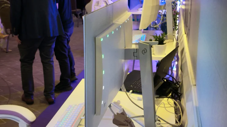 The rear of a Philips Evnia gaming monitor, showing the Ambiglow lights in action