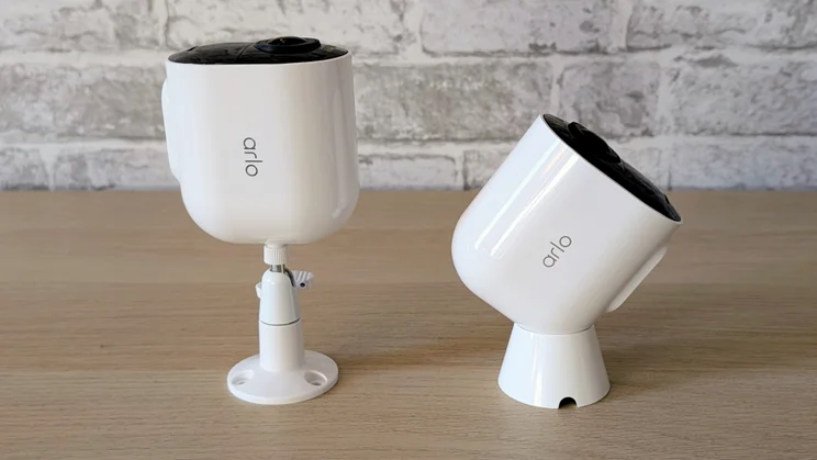 Two Arlo Ultra 3 security cameras, pictured with their ball and socket and magnetic mounts