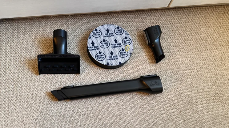 The Vax LiftOut Multi Pet Design Upright Vacuum's crevice attachments and filter laid out on a carpeted floor