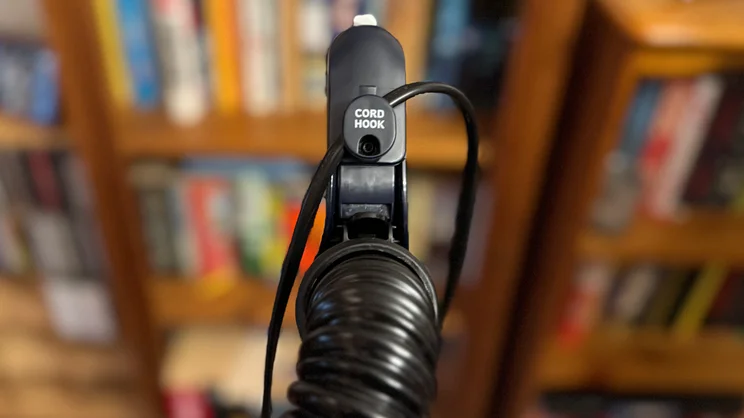 A closeup of the top of the Vax LiftOut Multi Pet Design Upright Vacuum's handle and cord hook