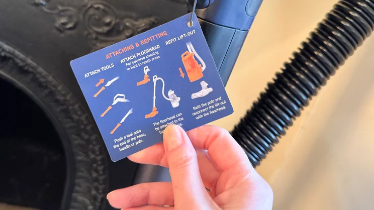 A closeup of an instruction card detailing how to use the Vax LiftOut Multi Pet Design Upright Vacuum
