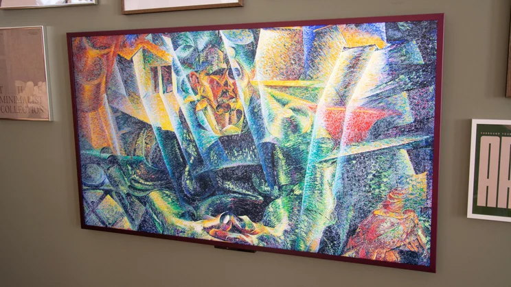 The Amazon Ember Artline QLED TV on a wall displaying a multi-coloured artwork