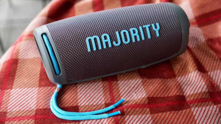 The Majority Move M3 portable Bluetooth speaker on a tartan quilt