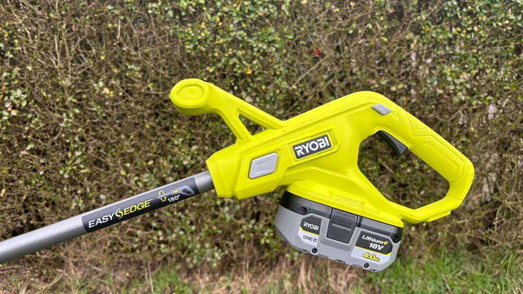 Ryobi RY18LT23A-0 grass trimmer - close-up of handle with battery pack attached
