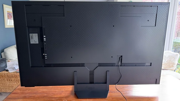 Rear view of the Samsung R95H Micro LED TV on a wooden table in a conservatory