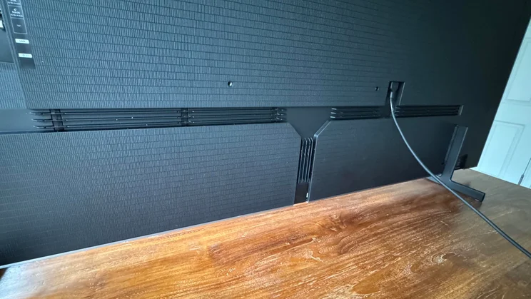 Rear view of the Samsung S99H quantum dot OLED TV showing the cable channels