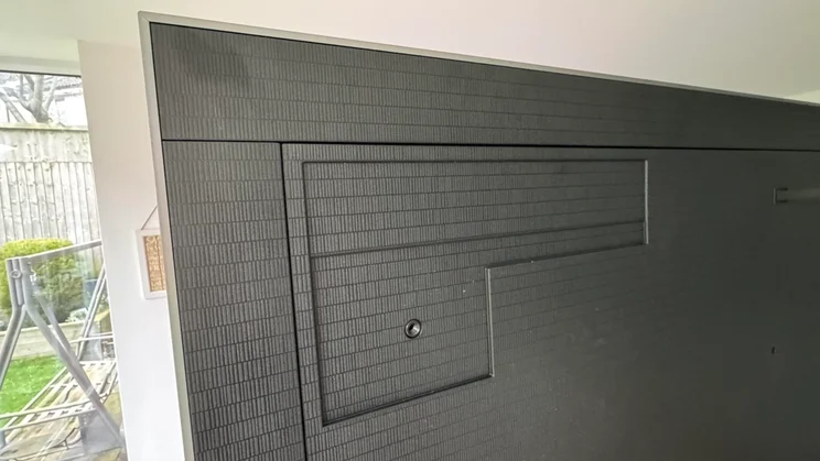 Rear view of the Samsung S99H quantum dot OLED TV showing the wall bracket slot