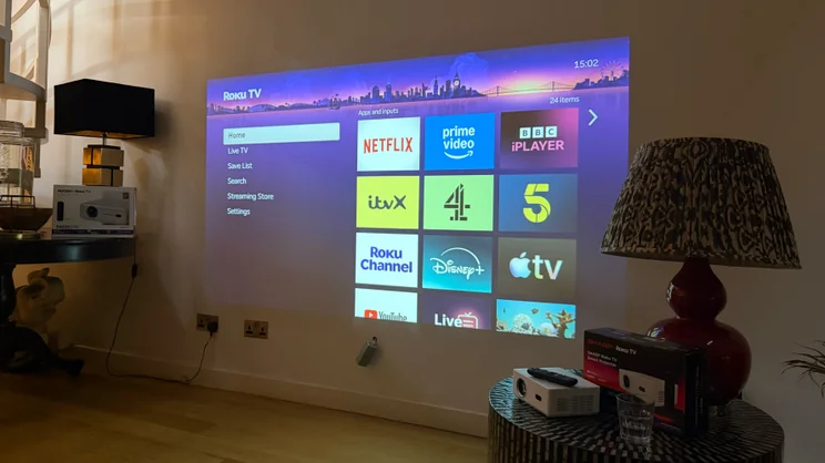 An image of the Roku TV interface projected on a wall