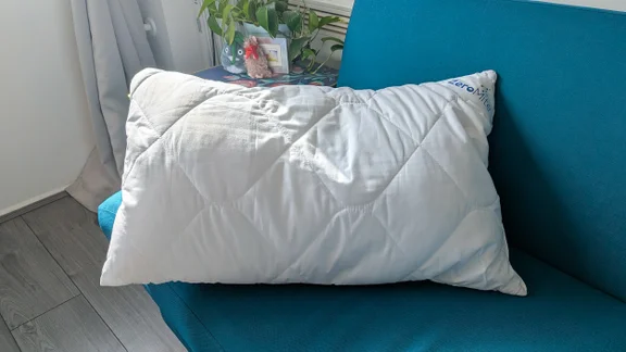 The Cuddledown ZeroMite Hygienic Washable Pillow on a blue sofa