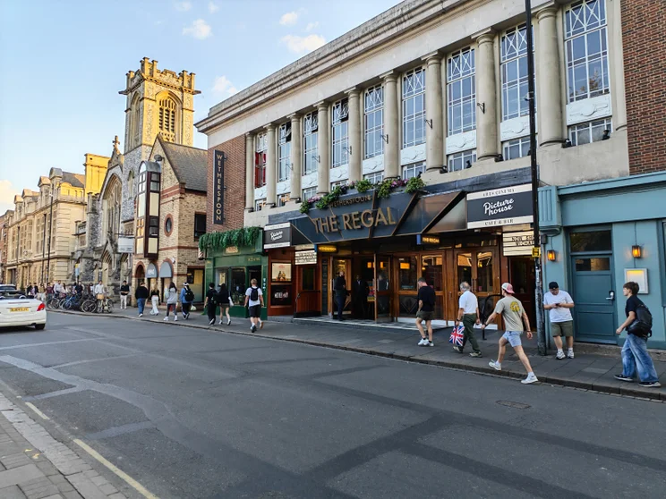 A quiet street with a church and a pub