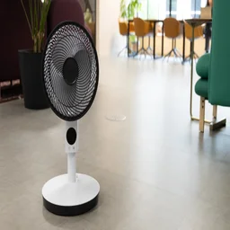 The Meaco Sefte Pro 10in Pedestal Fan at its lowest height on the floor of an office
