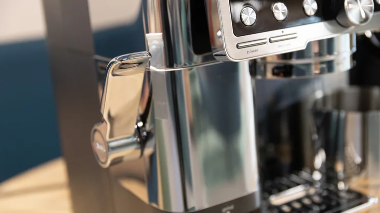 A closeup of the Ninja Luxe Cafe Pro espresso machine's grinder and tamping lever