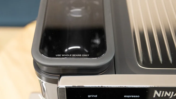 A closeup of the Ninja Luxe Cafe Pro espresso machine's bean hopper with lid on