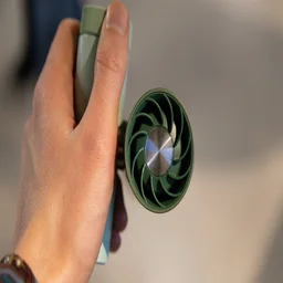 The Shark ChillPill portable fan, held with fan facing the camera