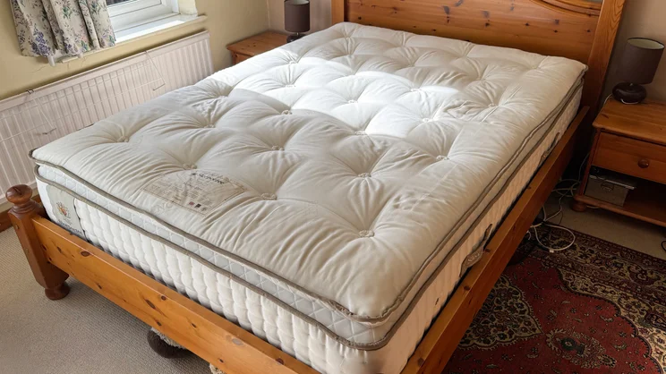 The Sleepeezee Regency Kennington 4200 mattress on a wooden bed frame in a bedroom