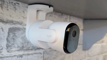 The Arlo Essential 3 pan tilt security camera mounted on the underside of a shelf