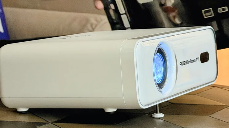 The Aurzen Roku TV Smart Projector pictured fro the front left quarter