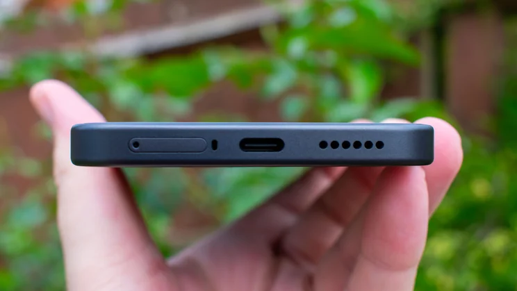 Xiaomi 17T in hand, bottom view