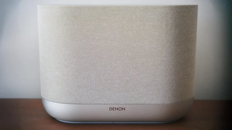 Front view of the Denon Home 400 wireless speaker on a wooden table