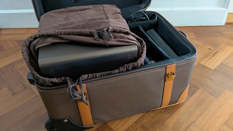 The leather luggage case included with the Hisense XR10, with the projector and its accessories inside