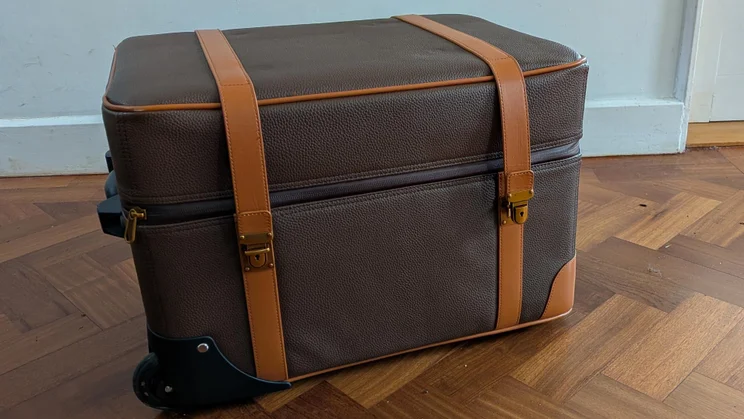 The leather luggage case included with the Hisense XR10 projector with the top zipped closed