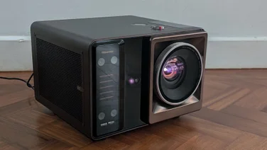 Front view of the Hisense XR10 projector on a wooden floor pointing to the right