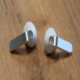 The Samsung Galaxy Buds4 on a wooden table