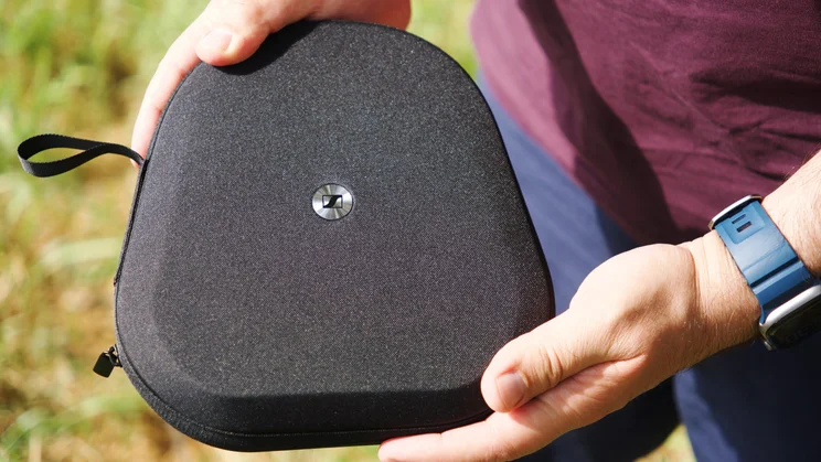 Our reviewer holding the closed carrying case of the Sennheiser Momentum 5 Wireless over-ear headphones