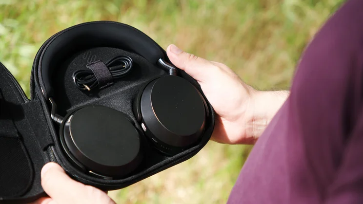 The carrying case of the Sennheiser Momentum 5 Wireless over-ear headphones open with the headphones inside