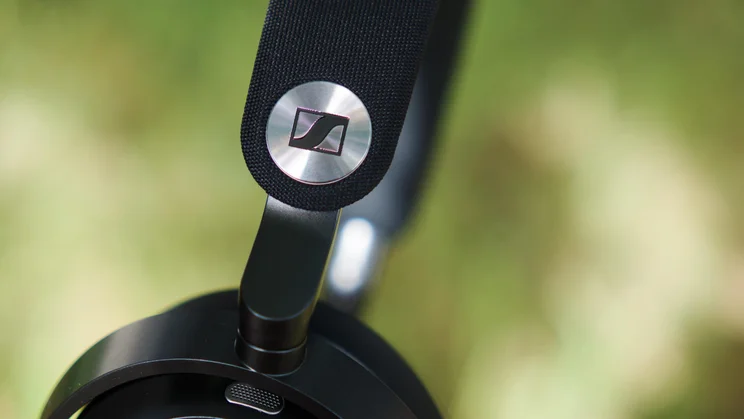 The Sennheiser logo on the headband of the Sennheiser Momentum 5 Wireless over-ear headphones
