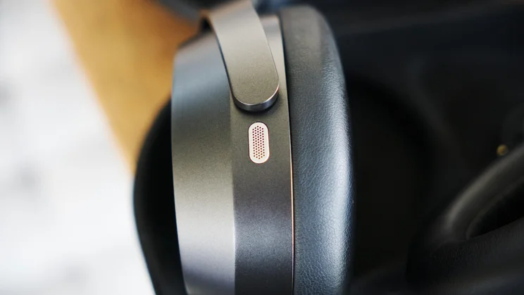 One of the microphones on the outside of the earcup of the Sennheiser Momentum 5 Wireless over-ear headphones
