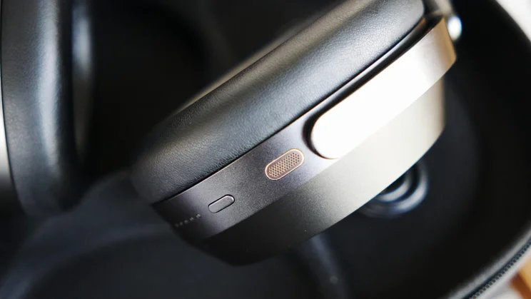 The power button on the earcup of the Sennheiser Momentum 5 Wireless over-ear headphones