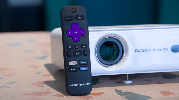 A Roku remote control leaning against the Aurzen Eazze D1R