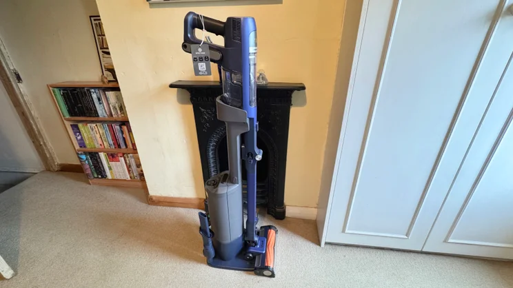 A picture, from the right side, of the Shark PowerDetect Speed Clean and Empty Pet Pro in its docking station